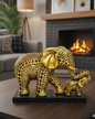 Gold elephant figurines on a table in a cozy living room with a fireplace.