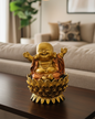 Gold Buddha statue on a table in a living room setting